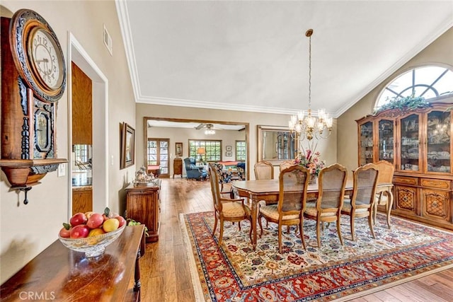 dining room with ornamental molding, hardwood / wood-style flooring, and plenty of natural light