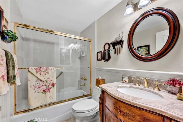 full bath featuring enclosed tub / shower combo, toilet, a textured wall, and vanity