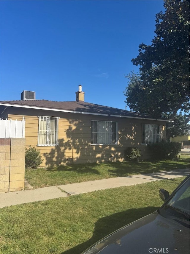 1301 E 106th St, Los Angeles, CA 90002 - ranch-style home with a chimney, cooling unit, and a front lawn