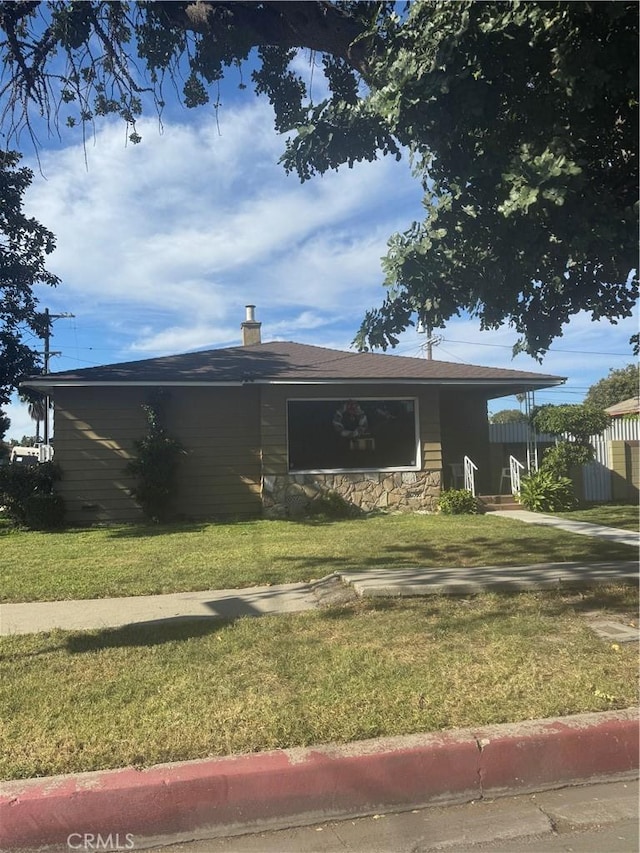 view of side of home with a yard
