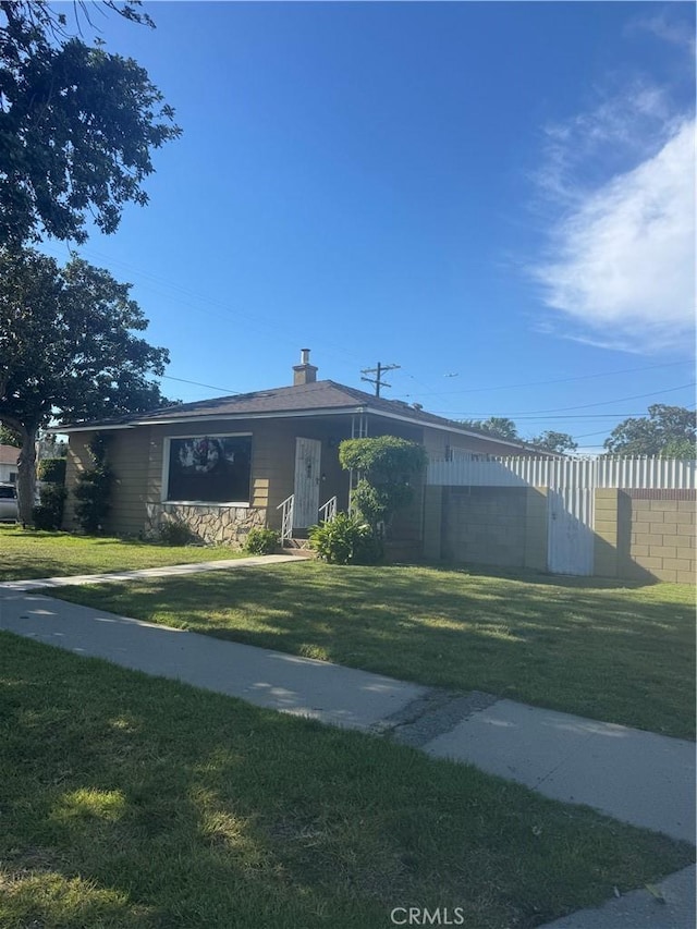 1301 E 106th St, Los Angeles, CA 90002 - view of front of home featuring a chimney and a front lawn
