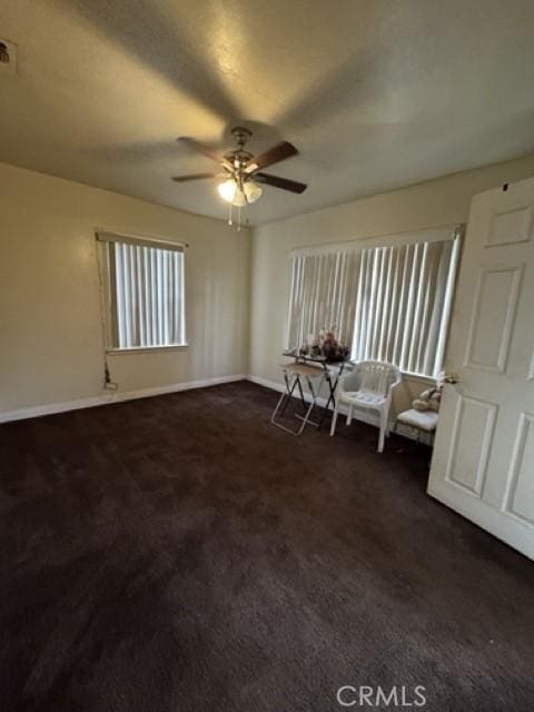 1301 E 106th St, Los Angeles, CA 90002 - interior space with ceiling fan, dark colored carpet, baseboards, and multiple windows