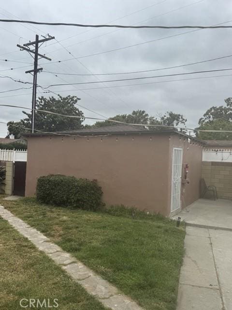 1301 E 106th St, Los Angeles, CA 90002 - view of property exterior with a yard, stucco siding, and fence