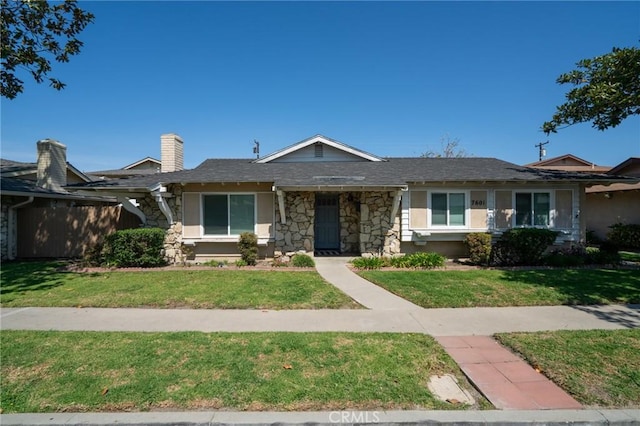 view of front of property featuring stone siding and a front yard