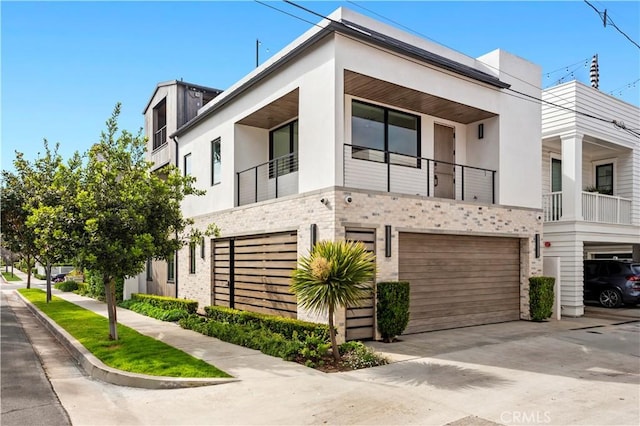 429 Marigold Ave, Corona Del Mar, CA 92625 - view of front of house with concrete driveway, stone siding, stucco siding, and a garage