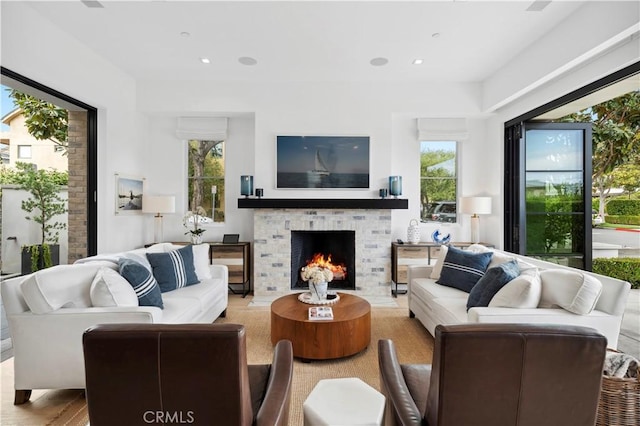 429 Marigold Ave, Corona Del Mar, CA 92625 - living room featuring plenty of natural light, a warm lit fireplace, wood finished floors, and recessed lighting
