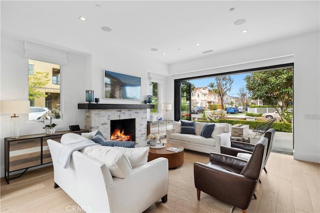 429 Marigold Ave, Corona Del Mar, CA 92625 - living room with a wealth of natural light, light wood-style floors, a lit fireplace, and recessed lighting