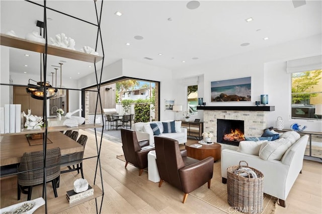 429 Marigold Ave, Corona Del Mar, CA 92625 - living room featuring light wood-style flooring, a brick fireplace, a notable chandelier, and recessed lighting