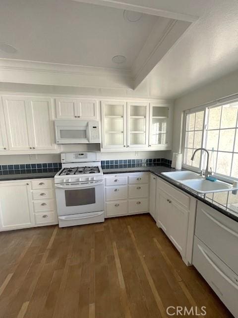 kitchen with white appliances, a sink, ornamental molding, white cabinets, and dark wood-type flooring
