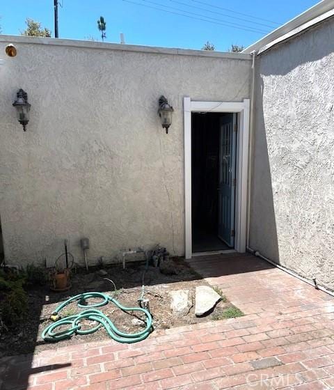 property entrance with stucco siding