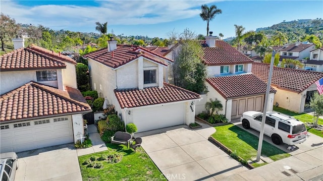 mediterranean / spanish-style house with a residential view, a garage, stucco siding, a chimney, and a tiled roof