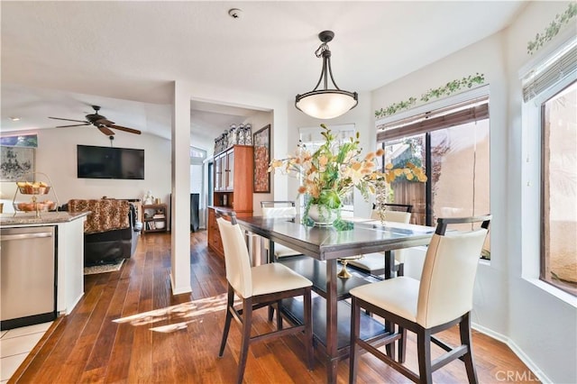 dining room with wood-type flooring, baseboards, and ceiling fan