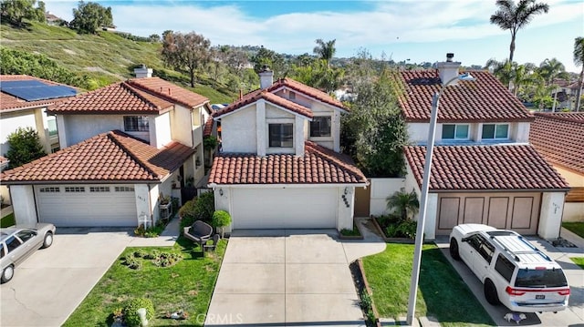 view of front facade featuring a residential view, stucco siding, and a tile roof
