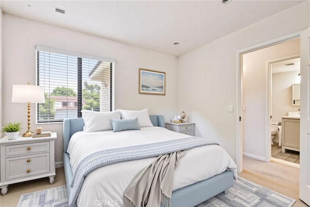3014 Enrique Unit 98, San Clemente, CA 92673 - bedroom with light colored carpet, baseboards, and ensuite bathroom