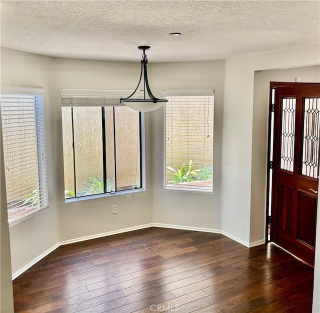 3014 Enrique Unit 98, San Clemente, CA 92673 - entryway with healthy amount of natural light, dark wood-style floors, and a textured ceiling