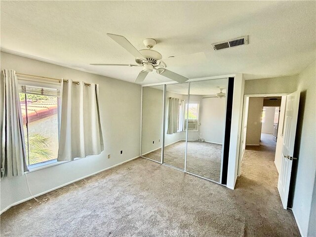 3014 Enrique Unit 98, San Clemente, CA 92673 - unfurnished bedroom featuring carpet floors, a closet, ceiling fan, and a textured ceiling