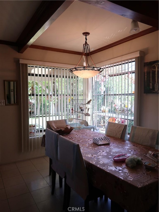 dining space featuring tile patterned floors and crown molding