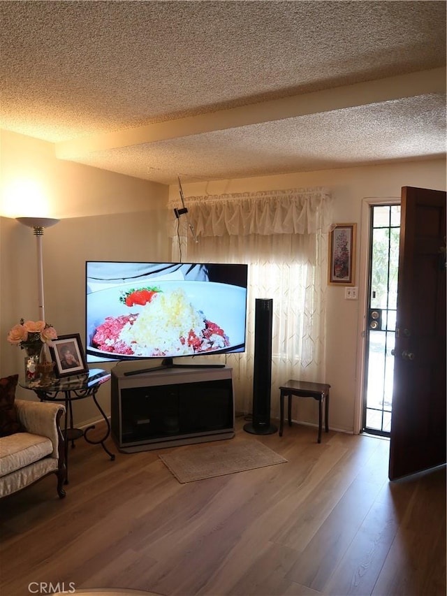 dining space with a textured ceiling and wood finished floors