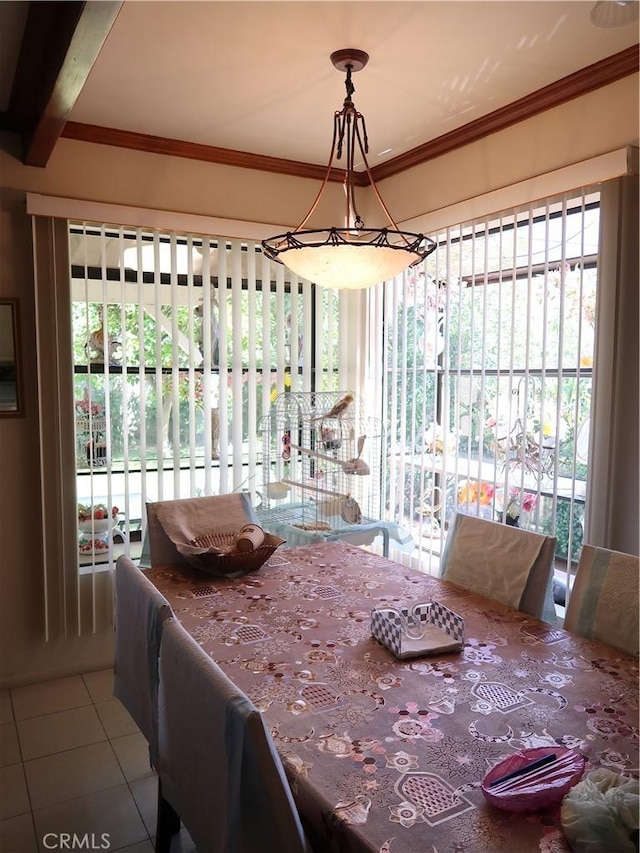 dining room featuring crown molding, tile patterned flooring, and a wealth of natural light
