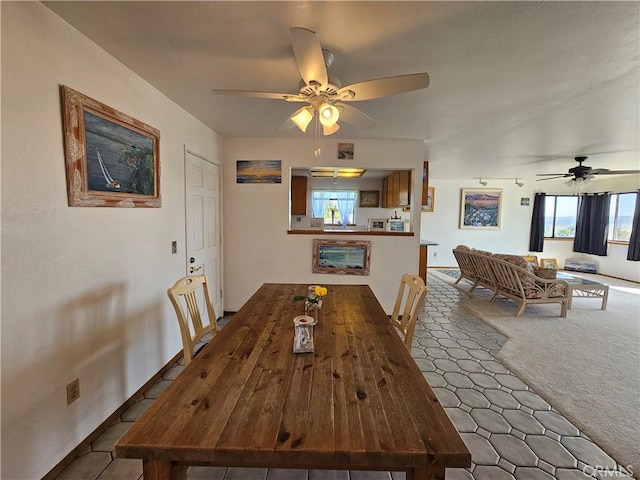 carpeted dining room featuring ceiling fan and a wealth of natural light