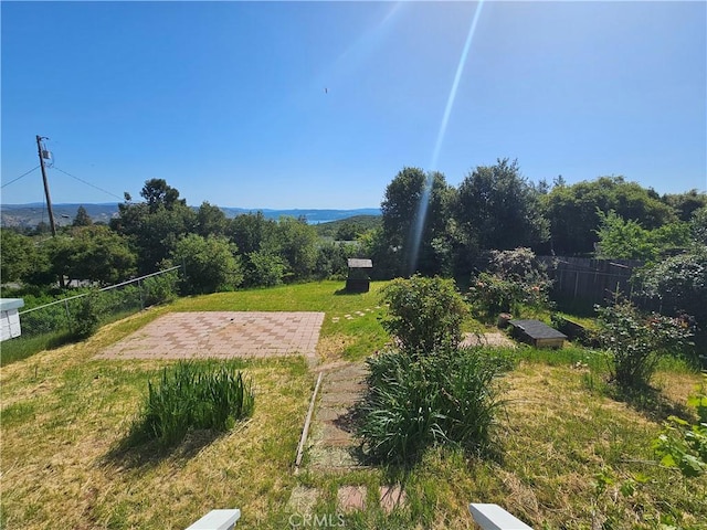 view of yard featuring fence and a patio