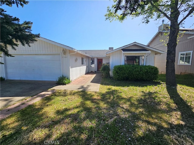 single story home with an attached garage, driveway, and a front yard
