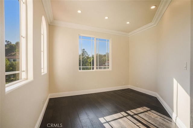 spare room featuring ornamental molding, dark wood-style flooring, baseboards, and recessed lighting