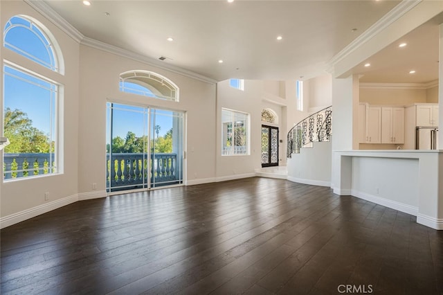 unfurnished living room featuring recessed lighting, stairway, a high ceiling, baseboards, and dark wood-style floors