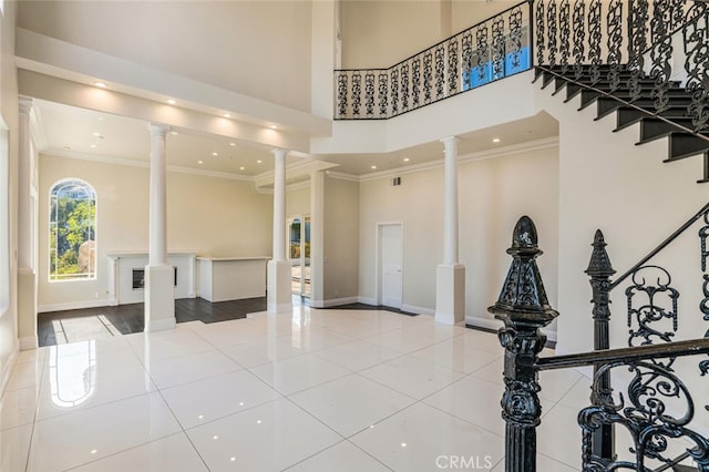 common area featuring ornamental molding, a high ceiling, stairs, and recessed lighting