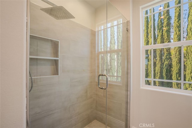 full bath with a stall shower and plenty of natural light