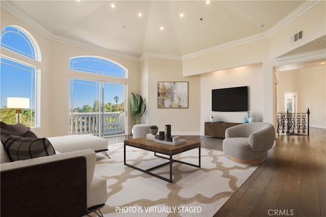 living area featuring high vaulted ceiling, healthy amount of natural light, hardwood / wood-style floors, recessed lighting, and ornamental molding