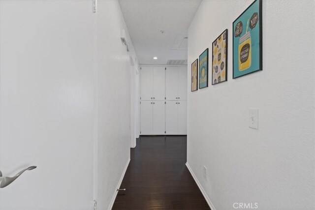 hall with recessed lighting, wood finished floors, and baseboards