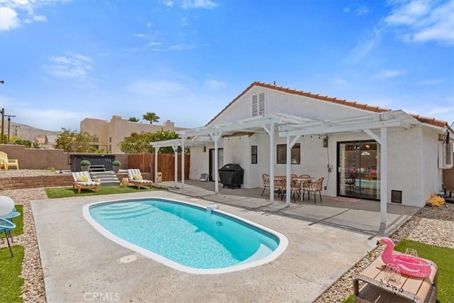 rear view of house featuring a fenced in pool, fence, a pergola, stucco siding, and a patio