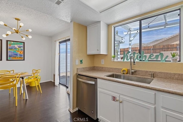 kitchen featuring white cabinets, stainless steel dishwasher, a textured ceiling, a sink, and dark wood-type flooring