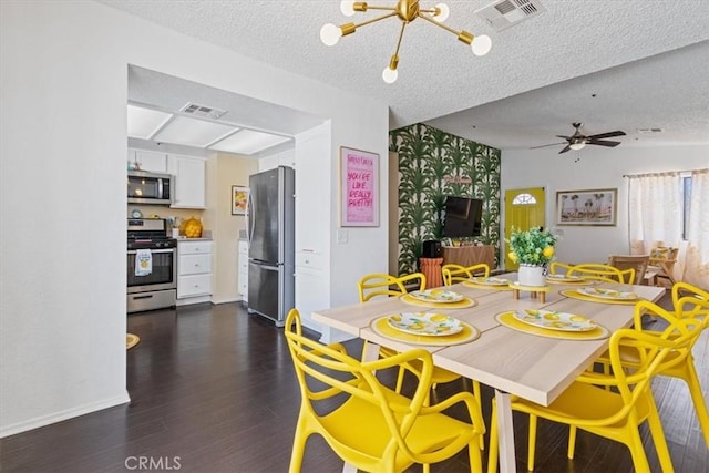 dining space with a chandelier, dark wood finished floors, visible vents, and a textured ceiling