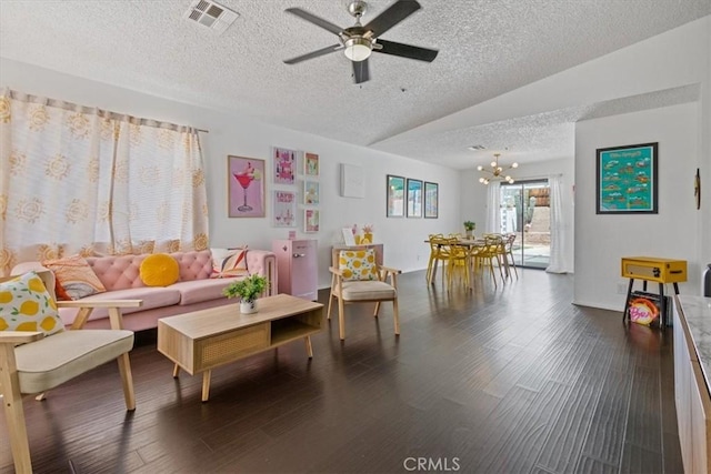 living room featuring a textured ceiling, vaulted ceiling, visible vents, ceiling fan with notable chandelier, and wood finished floors