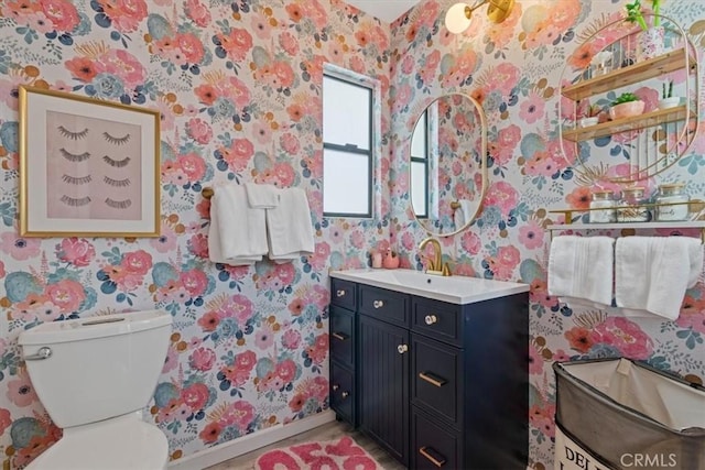 bathroom featuring wallpapered walls and baseboards