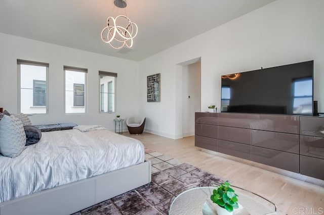 6222 Artisan Way, San Diego, CA 92130 - bedroom featuring light wood-type flooring, baseboards, a notable chandelier, and multiple windows