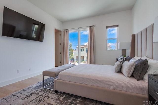 6222 Artisan Way, San Diego, CA 92130 - bedroom featuring baseboards, multiple windows, wood finished floors, and access to exterior