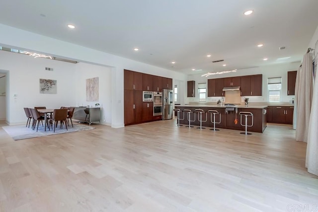 6222 Artisan Way, San Diego, CA 92130 - kitchen featuring under cabinet range hood, stainless steel appliances, a healthy amount of sunlight, and light countertops