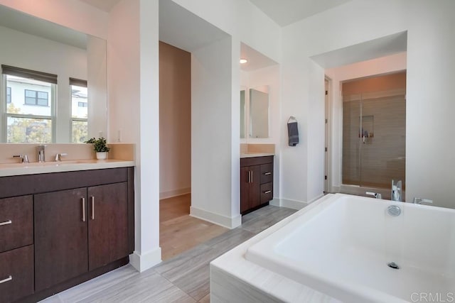 6222 Artisan Way, San Diego, CA 92130 - full bath featuring a washtub, a shower stall, two vanities, a sink, and baseboards