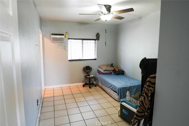342434241/2 Paloma St, Los Angeles, CA 90011 - bedroom featuring a wall unit AC, light tile patterned floors, ceiling fan, and baseboards