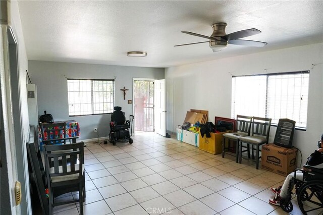 342434241/2 Paloma St, Los Angeles, CA 90011 - tiled living area featuring a ceiling fan and a textured ceiling