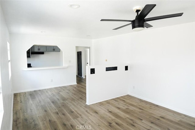 342434241/2 Paloma St, Los Angeles, CA 90011 - empty room featuring wood finished floors, ceiling fan, and baseboards