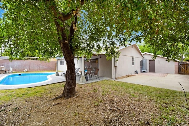 view of swimming pool featuring a fenced backyard and a patio