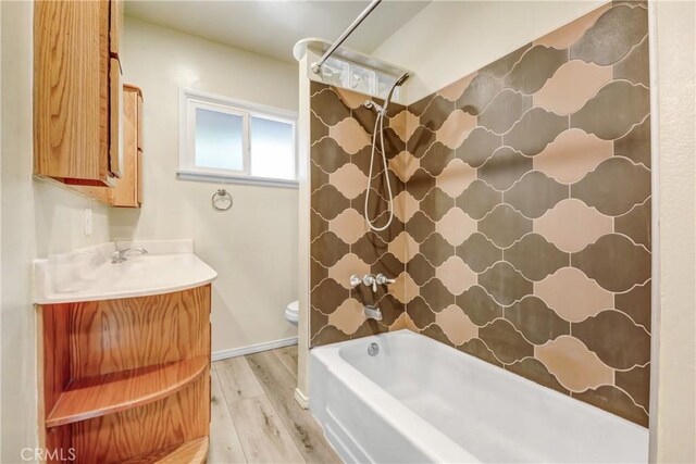 full bath with wood finished floors, toilet, vanity, and shower / bathtub combination with curtain