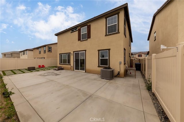 back of property with cooling unit, a patio, a fenced backyard, and stucco siding