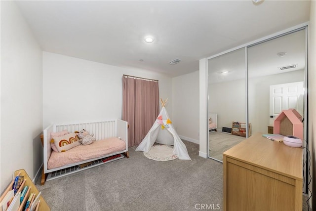 carpeted bedroom featuring recessed lighting, a closet, baseboards, and visible vents