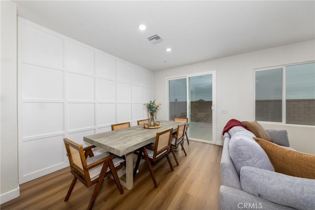 dining room with recessed lighting, wood finished floors, visible vents, and baseboards
