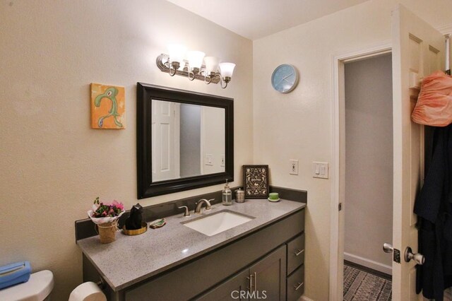 half bathroom with toilet and vanity